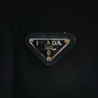 Black Prada logo patch with triangle metal badge on shorts