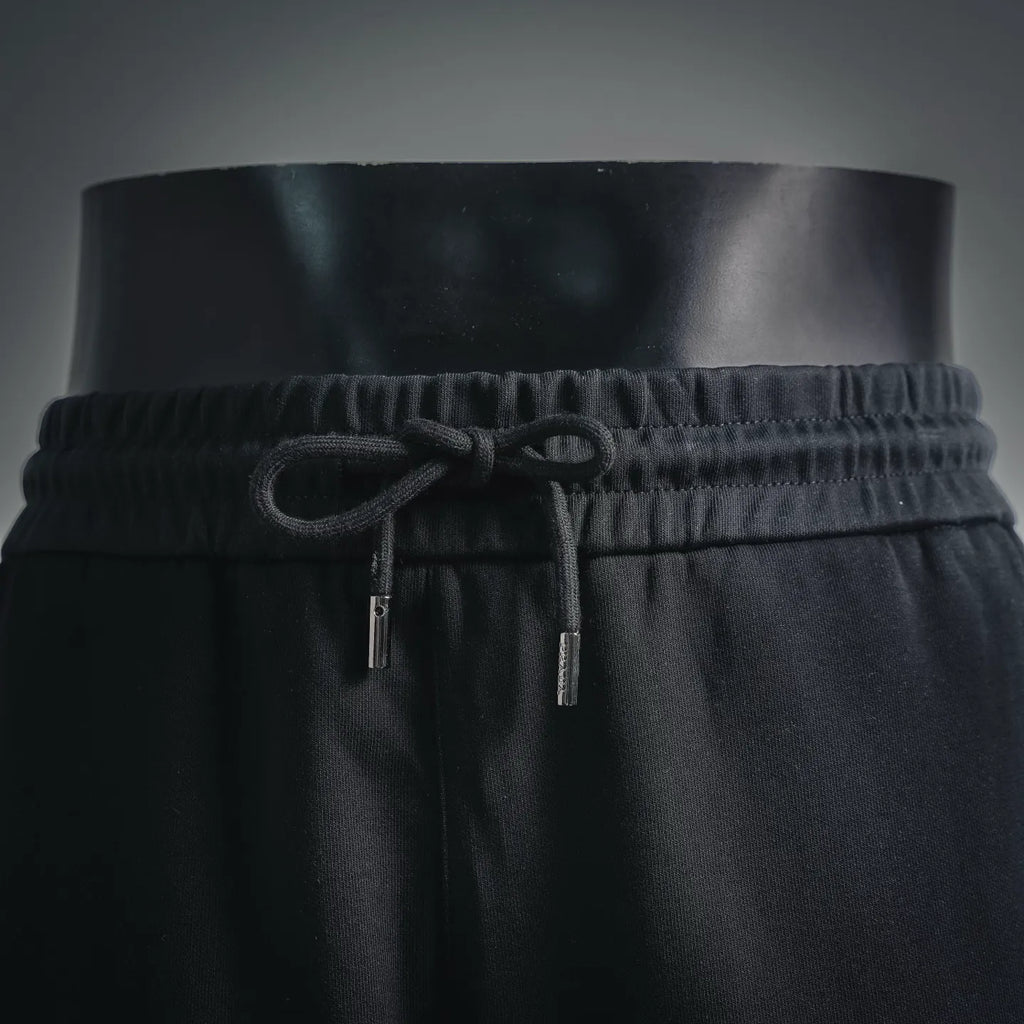 Black Prada shorts front: elastic waistband and drawstring