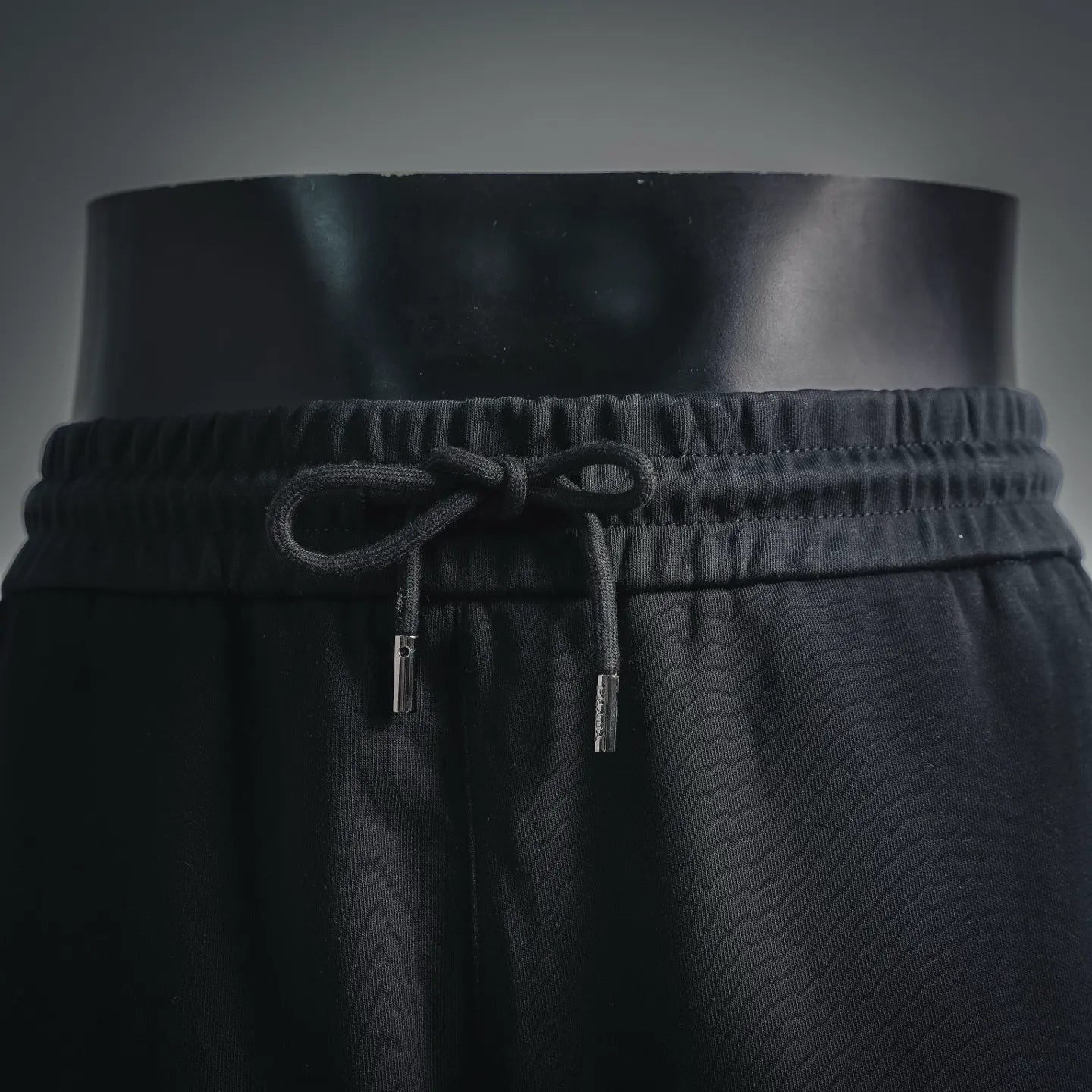 Black Prada shorts front: elastic waistband and drawstring