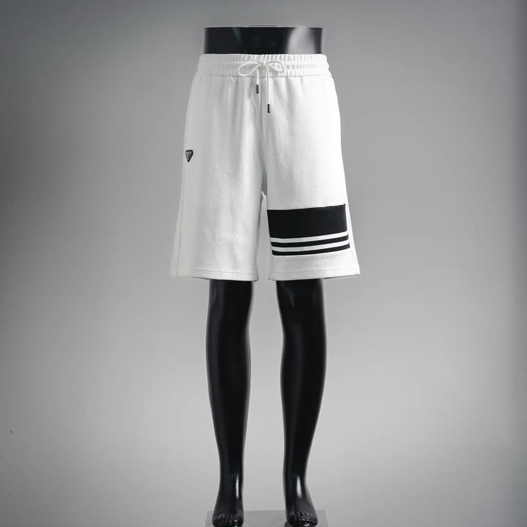 White drawstring shorts with black PRADA logo patch and striped hem trim