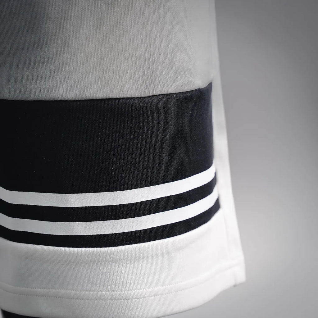 White shorts hem with black-and-white striped band accent