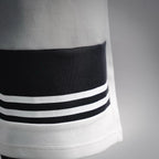 White shorts hem with black-and-white striped band accent