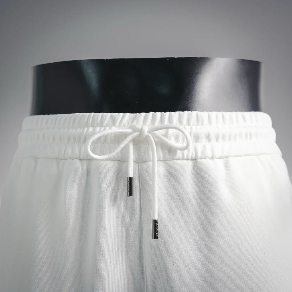 White drawstring shorts with elastic waistband and hanging cord