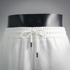 White drawstring shorts with elastic waistband and hanging cord