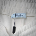White shorts with PRADA Milano logo tag and blue trimmed label
