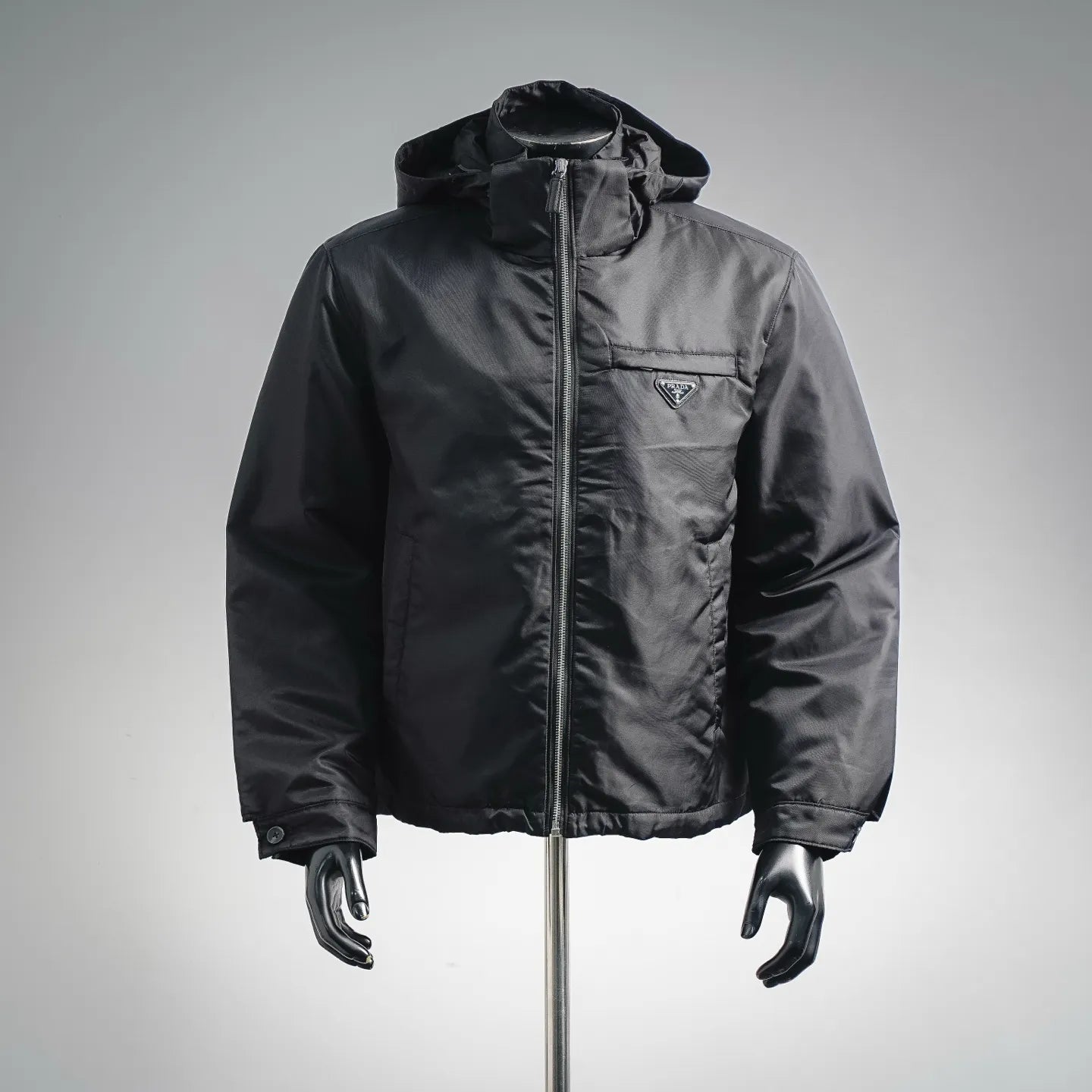 Black hooded zip-up jacket with Prada triangle logo at chest