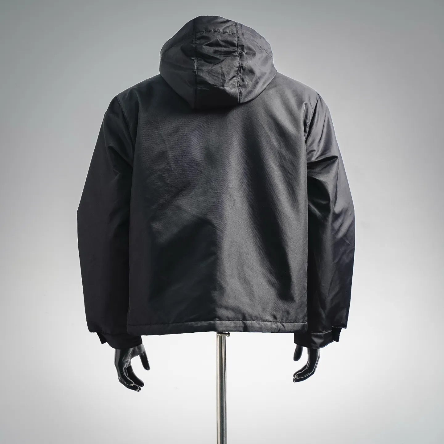 Black hooded zip-up jacket back view on mannequin