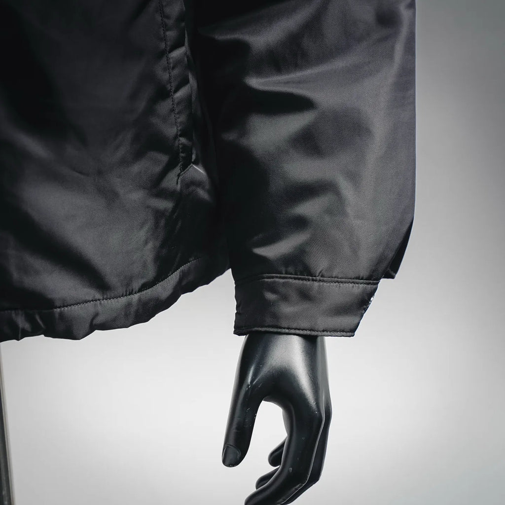Black jacket cuff and sleeve hem with stitched detail