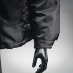 Black jacket cuff and sleeve hem with stitched detail