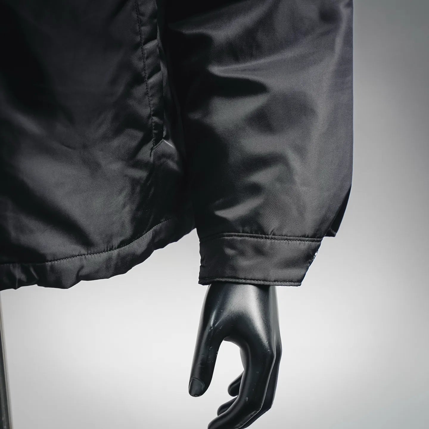 Black jacket cuff and sleeve hem with stitched detail