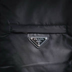 Prada logo triangle patch on front panel of black jacket