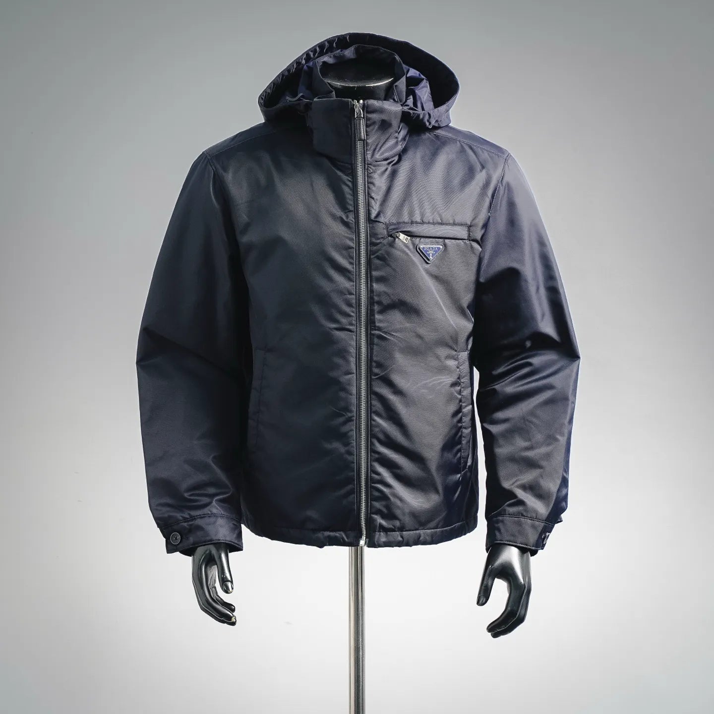 Navy hooded puffer jacket with full zip and triangular Prada chest logo patch