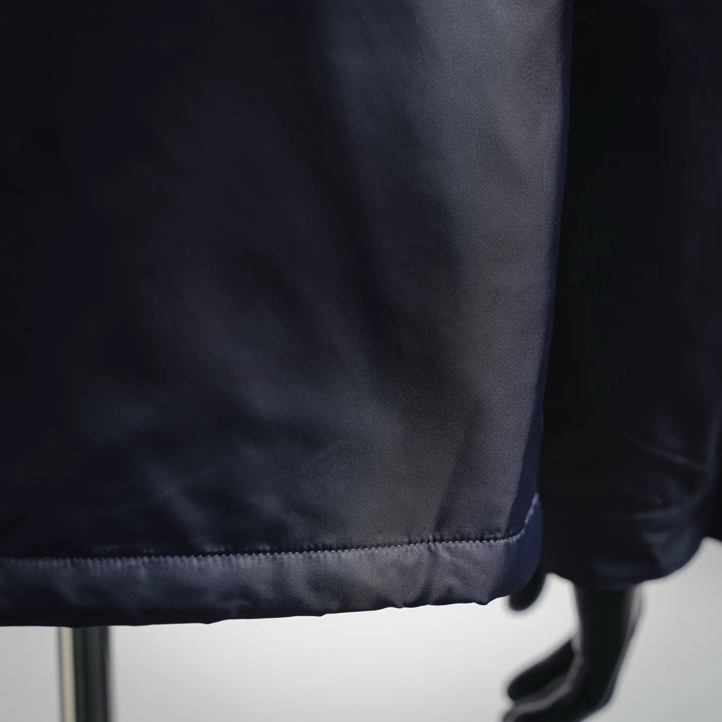Navy padded jacket hem with stitched cuff detail