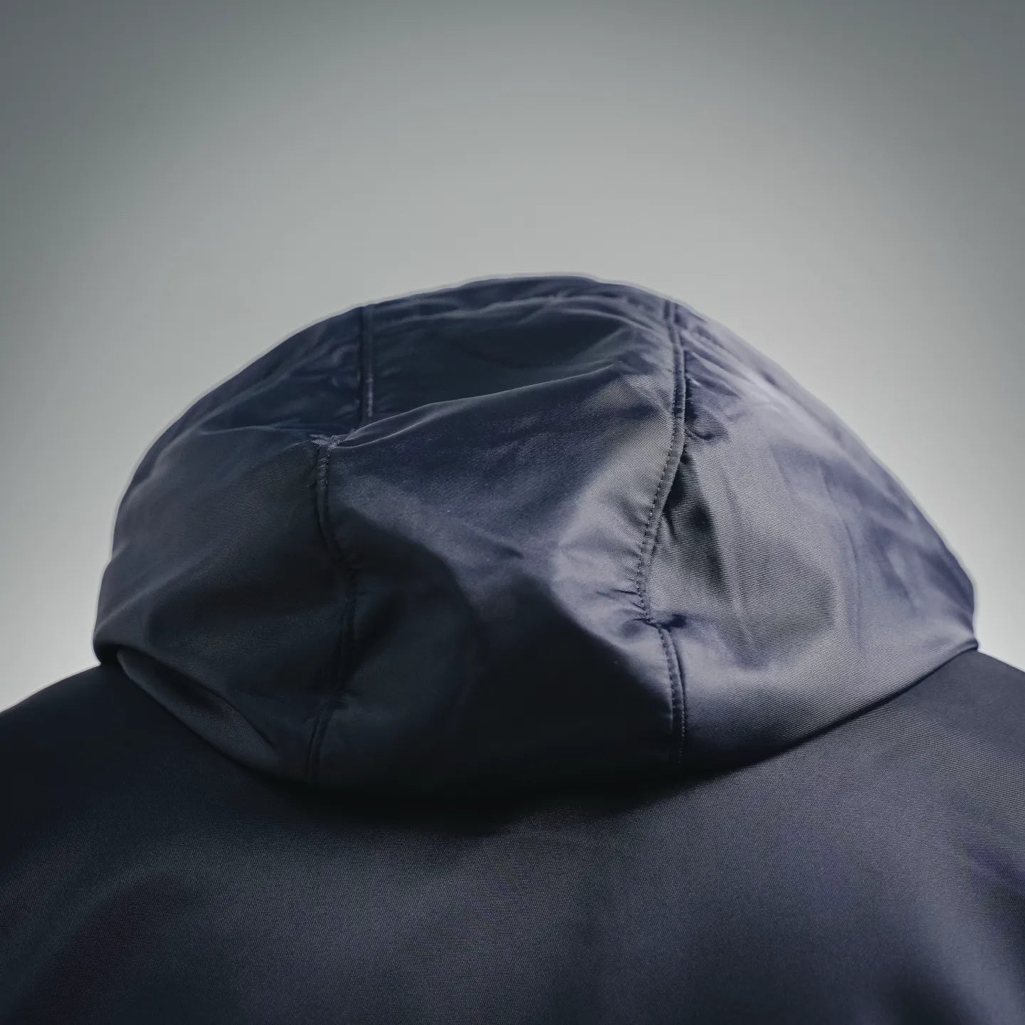 Navy hood with stitched seams on a padded jacket