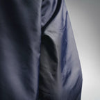 Navy jacket fabric close-up with smooth padded panel