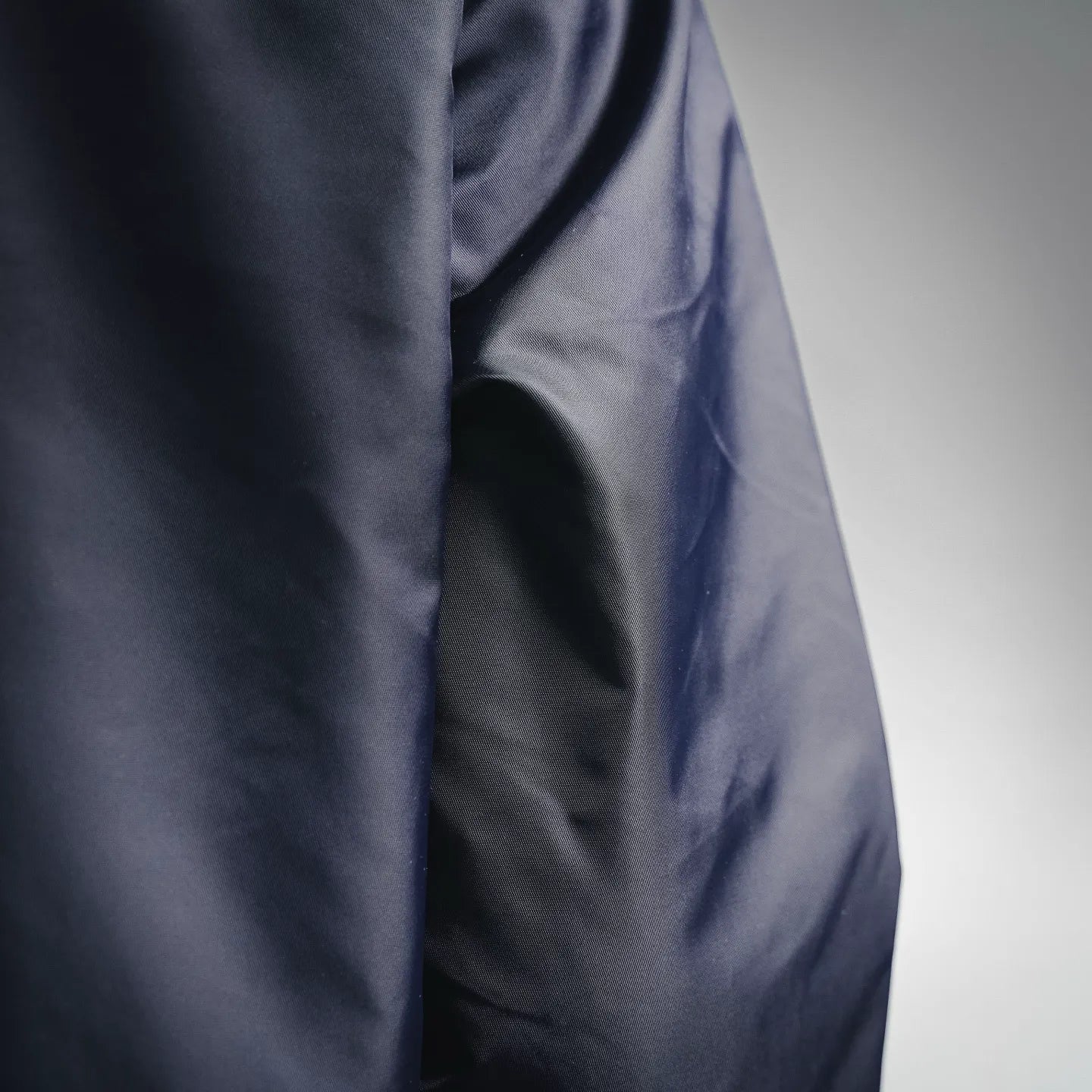 Navy jacket fabric close-up with smooth padded panel
