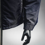 Navy puffer jacket sleeve with elastic cuff and stitched seam