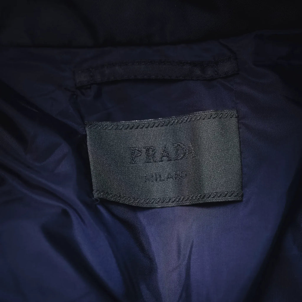 Prada fabric label on navy inner lining near collar seam