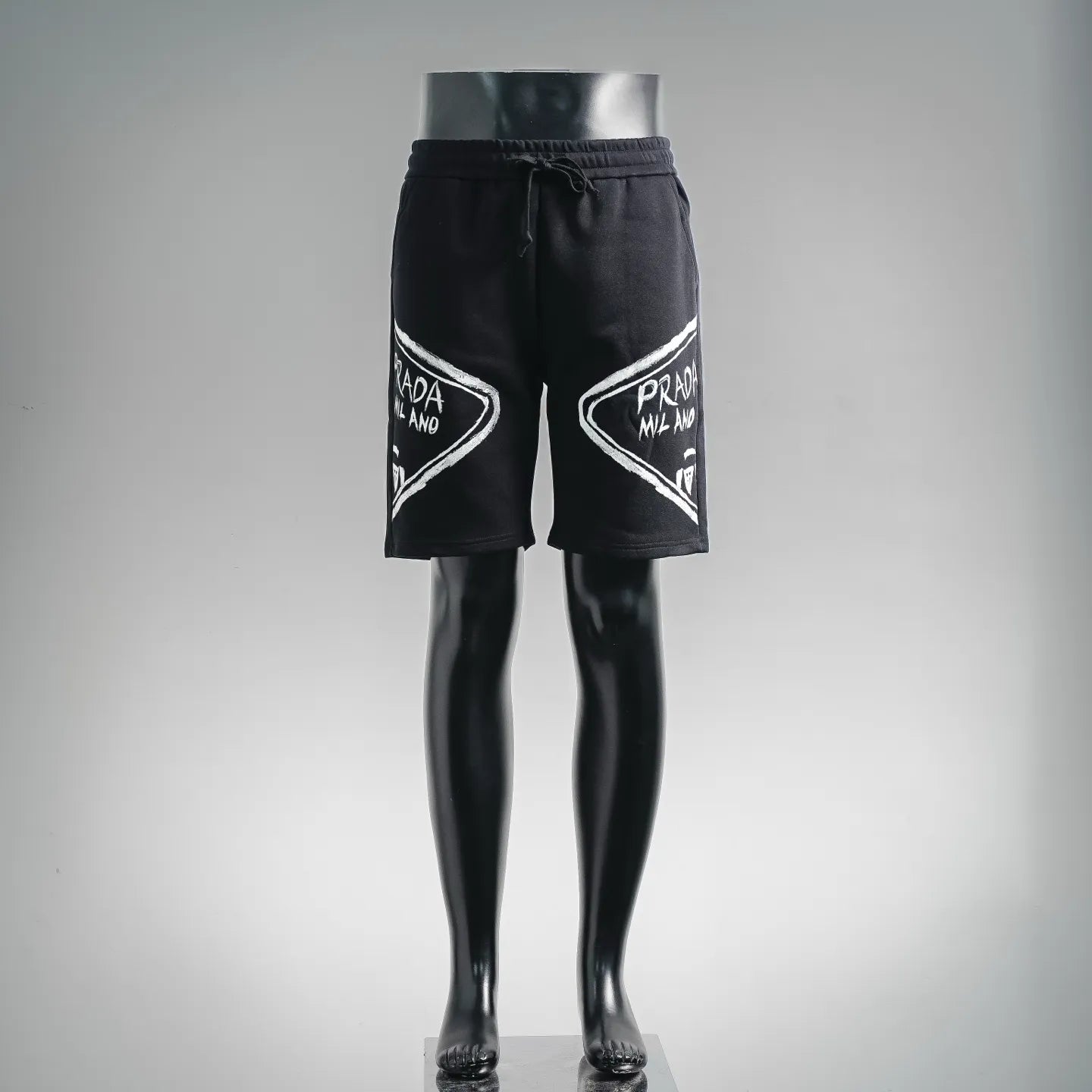 Black Prada logo shorts with elastic waistband and drawstring, front view