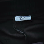 Black shorts fabric label and pocket opening with PRADA Milano tag