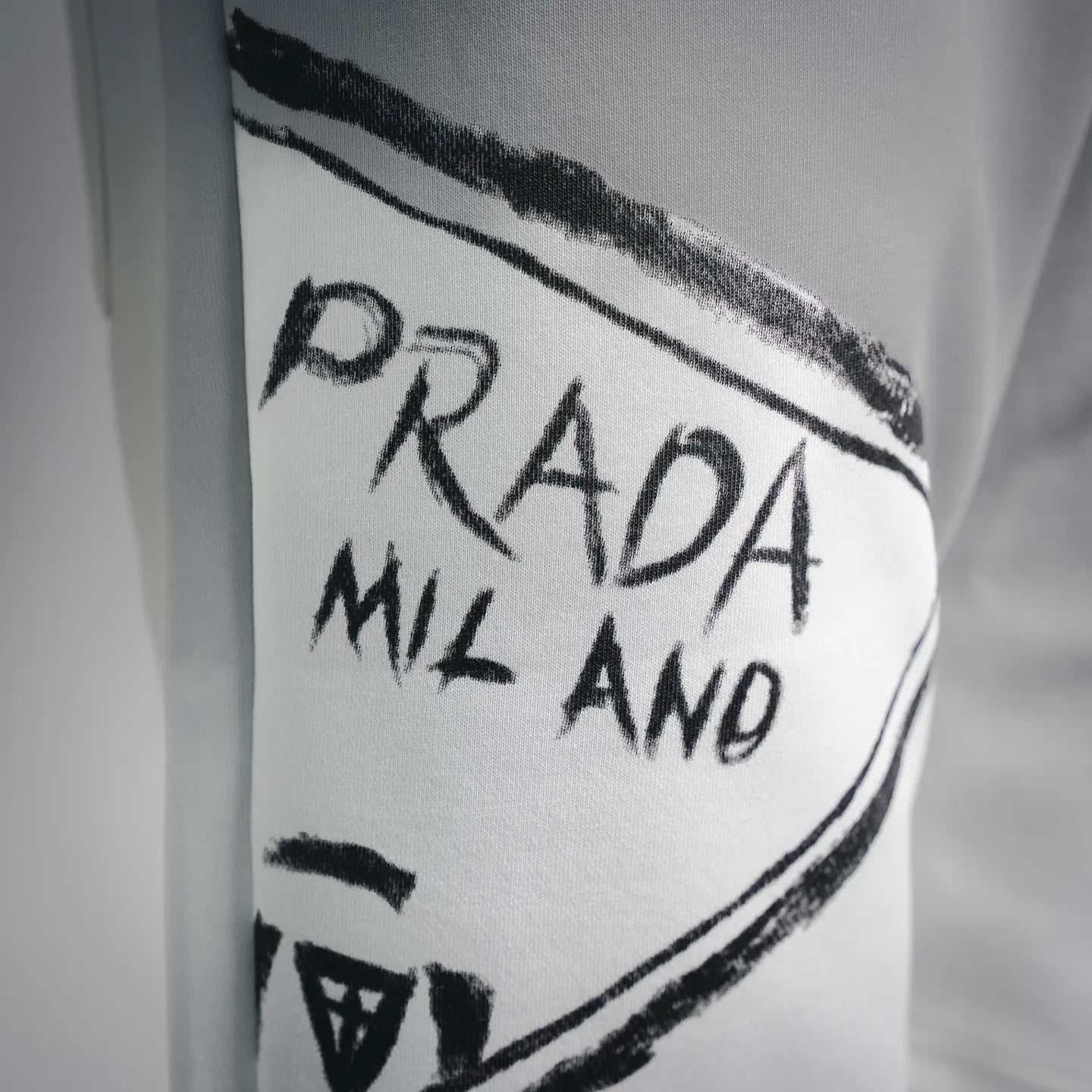 White shorts leg panel with Prada Milano logo print