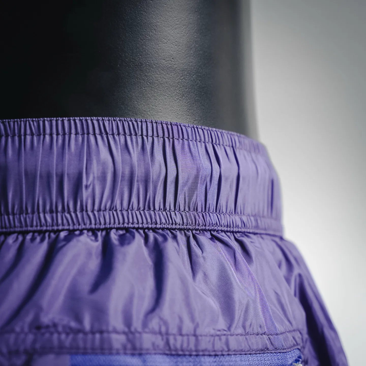 Prada purple shorts waistband close-up with elastic ruching and stitching