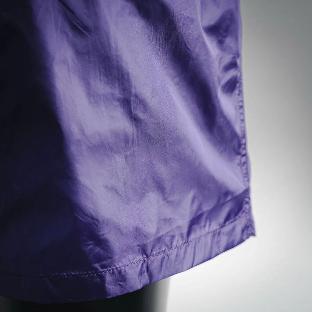 Prada purple nylon shorts hem close-up with gathered seam detail
