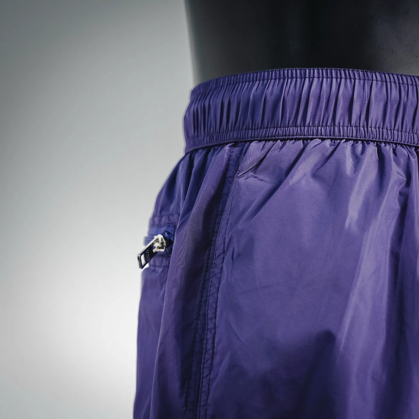 Prada purple nylon shorts side with hardware detail near the waistband