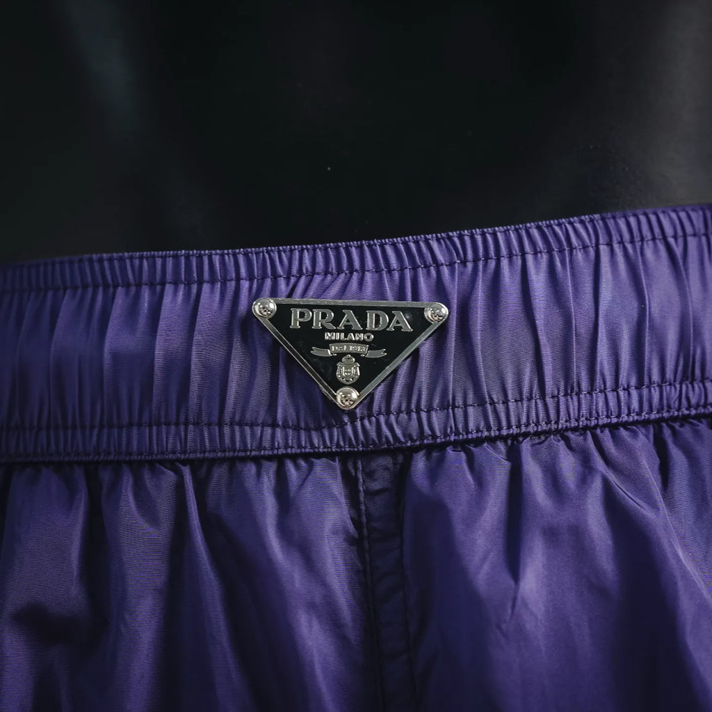 Prada logo patch on purple waistband of nylon shorts