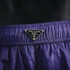 Prada logo patch on purple waistband of nylon shorts