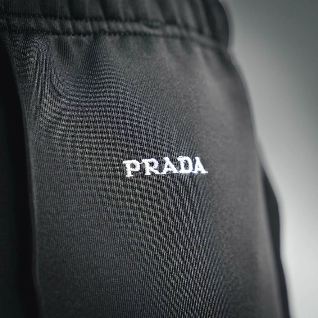 Prada dark pants with 'PRADA' logo print on the leg