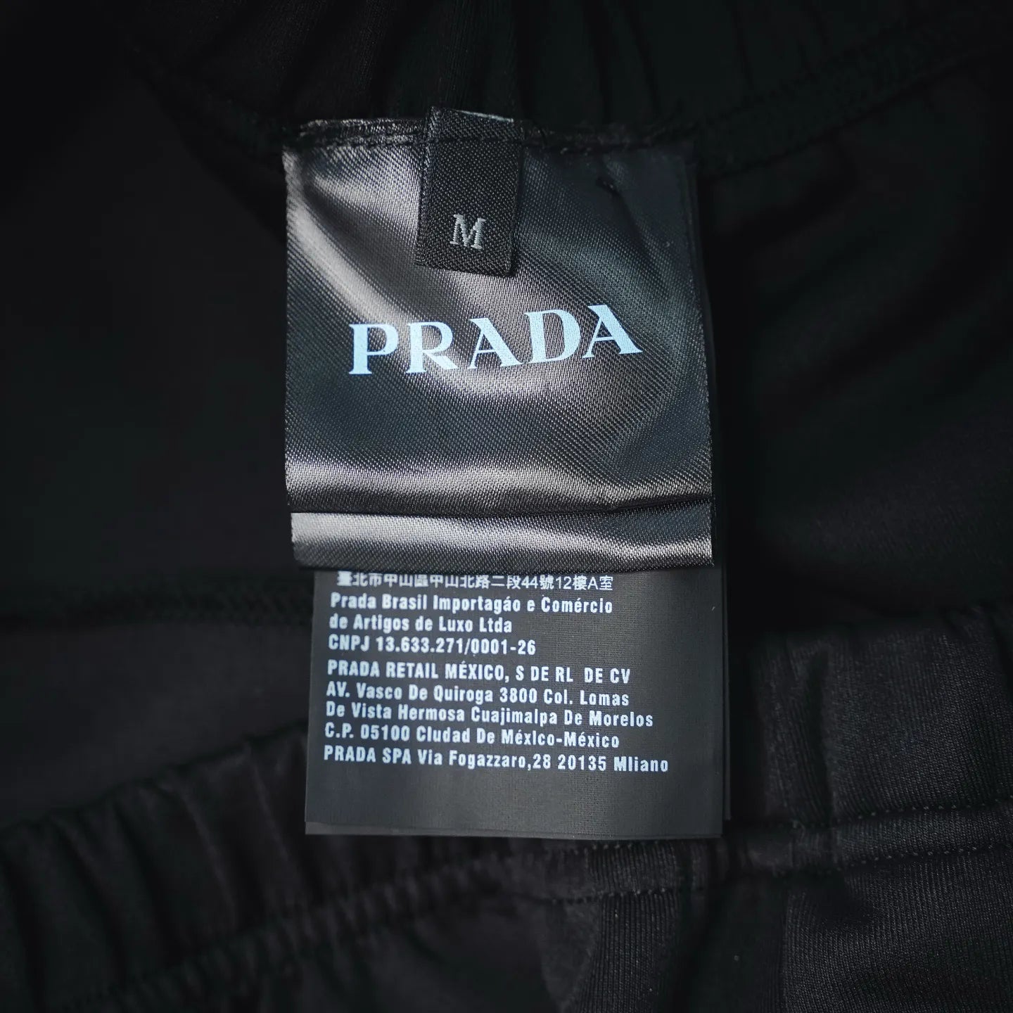 Prada dark pants interior label with size M and branding