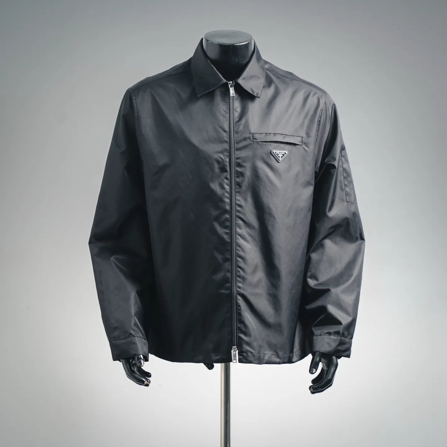 Prada dark gray zip-up jacket with stand collar and triangular logo pocket badge