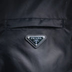 Prada logo badge on dark gray jacket back panel with stitched border
