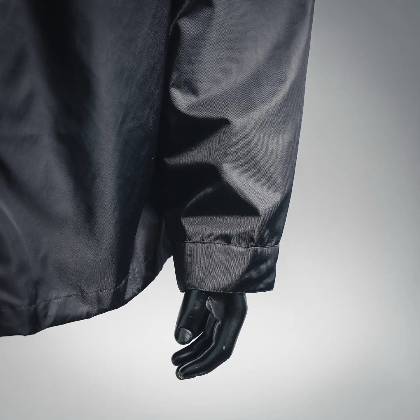 Dark gray jacket sleeve with elastic cuff and side seam detail