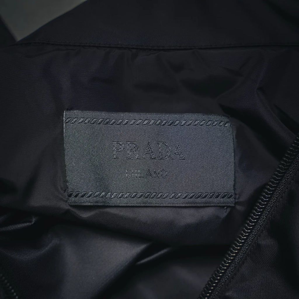 Prada Milano interior label on dark gray jacket with visible zipper track