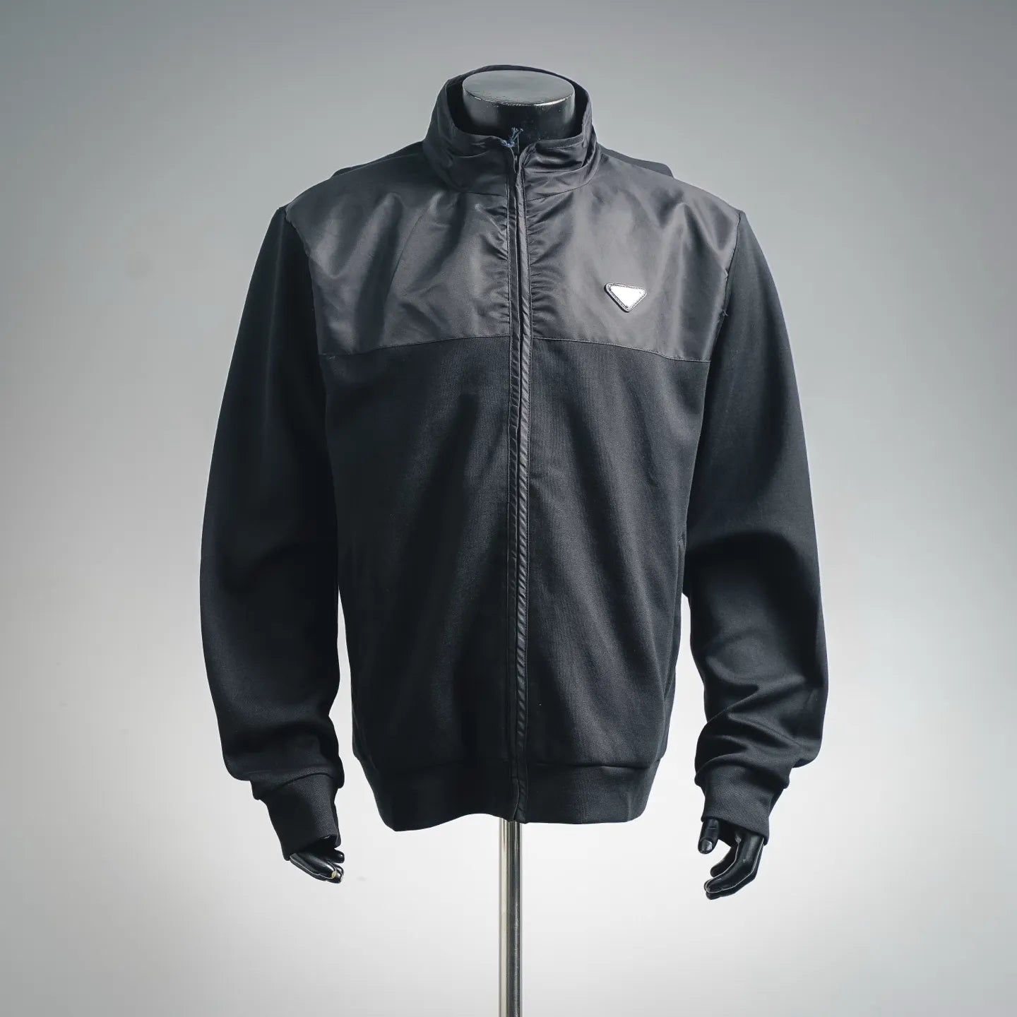 Prada dark zip-up jacket with stand collar and triangular logo patch