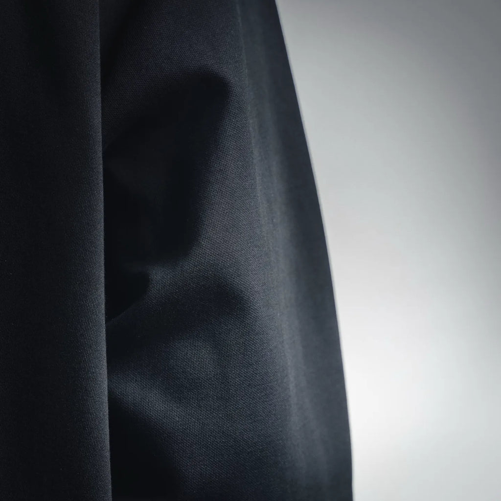 Prada dark jacket fabric close-up with subtle textured finish