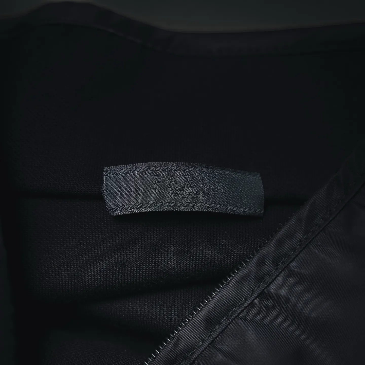 Prada dark jacket interior neck label and seam detail