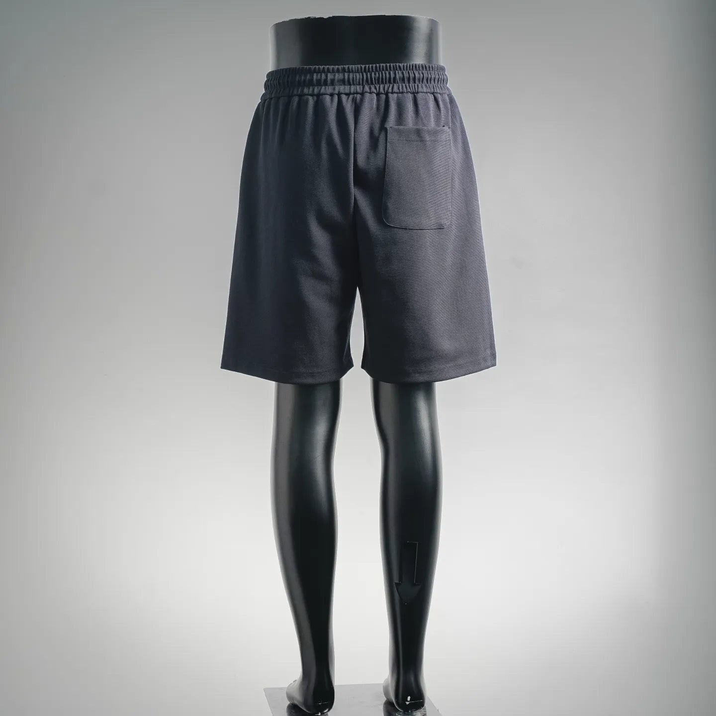 Dark drawstring shorts, rear view with elastic waist and patch pocket detail