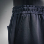 Dark elastic waistband with gathered texture and drawstring ties
