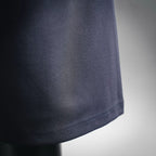 Dark shorts side hem with neat stitching and textured fabric