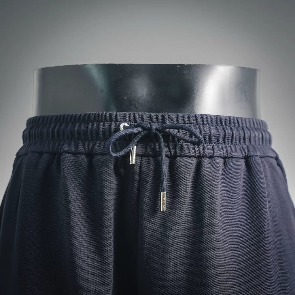 Dark drawstring shorts waistband with metal aglet cord and elastic channel