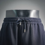 Dark drawstring shorts waistband with metal aglet cord and elastic channel