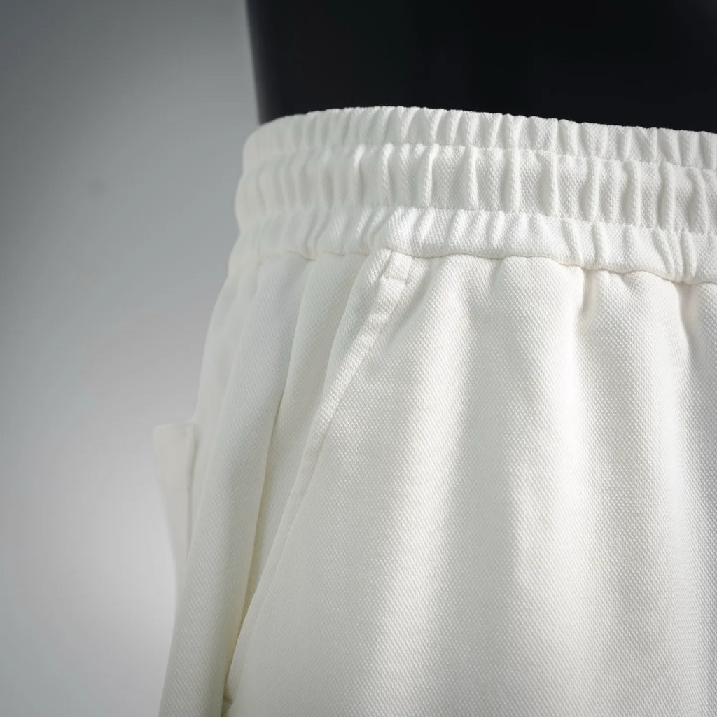 White shorts waistband with elastic gathers and relaxed leg drape