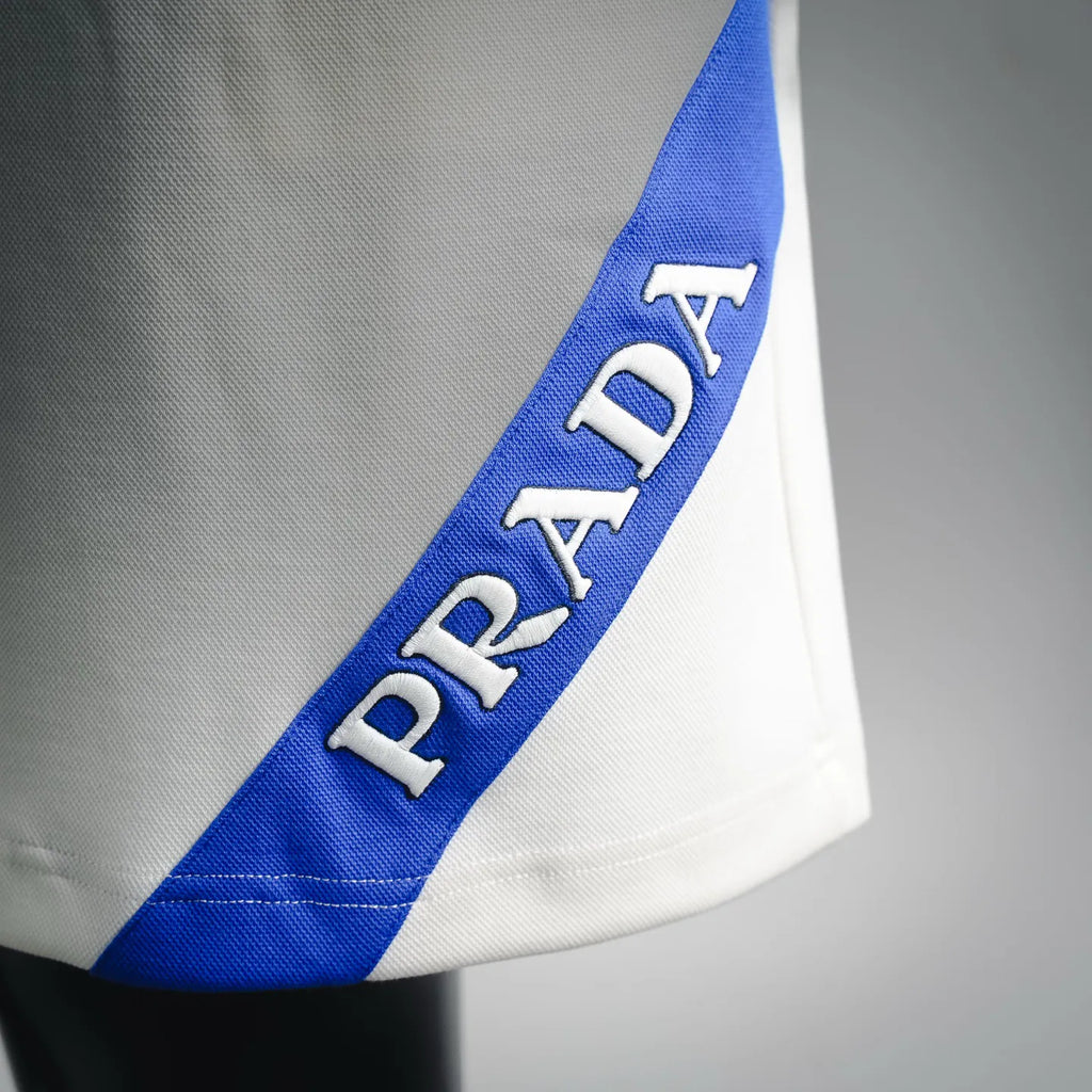 Blue side logo strap on white shorts with Prada lettering