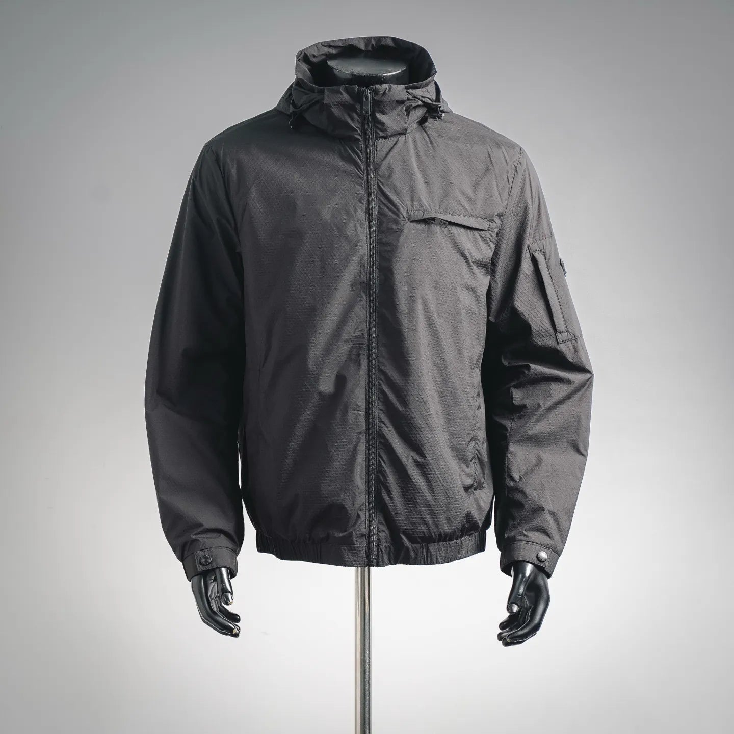 Black hooded jacket with full front zipper and front pocket on mannequin