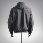 Black hooded jacket, back view with gathered hem and elastic cuffs