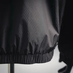 Black jacket hem with elastic band and textured diamond fabric pattern