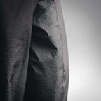 Close-up of black jacket fabric with textured diamond pattern